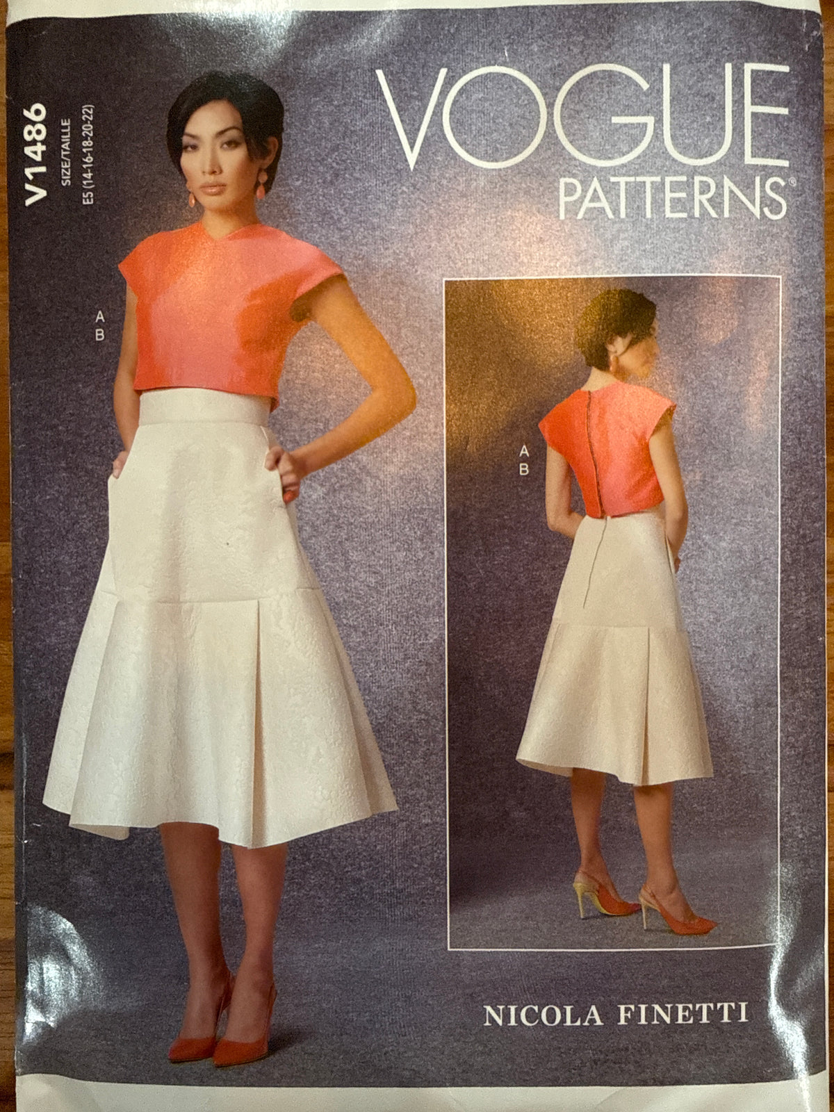 Vogue V1486 Nicola Finetti sewing pattern envelope showing a cropped cap-sleeve top and flared skirt.