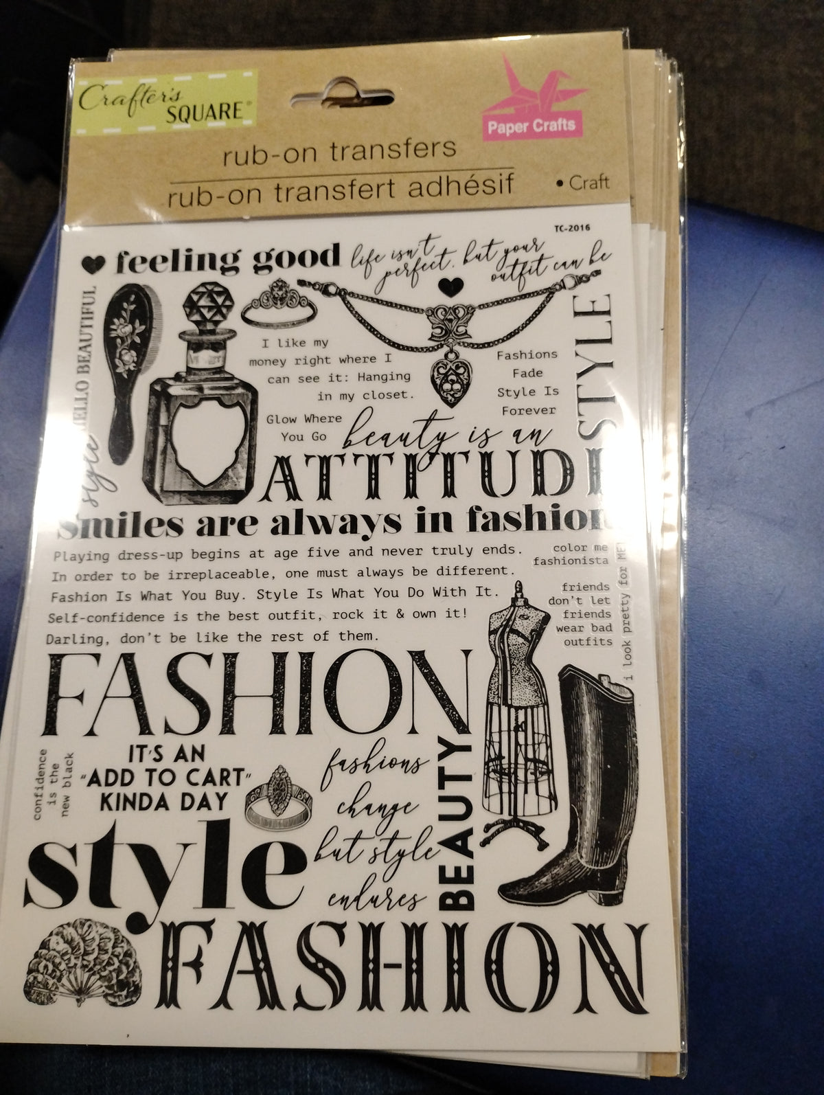 Rub on transfer features various quotes, a perfume bottle